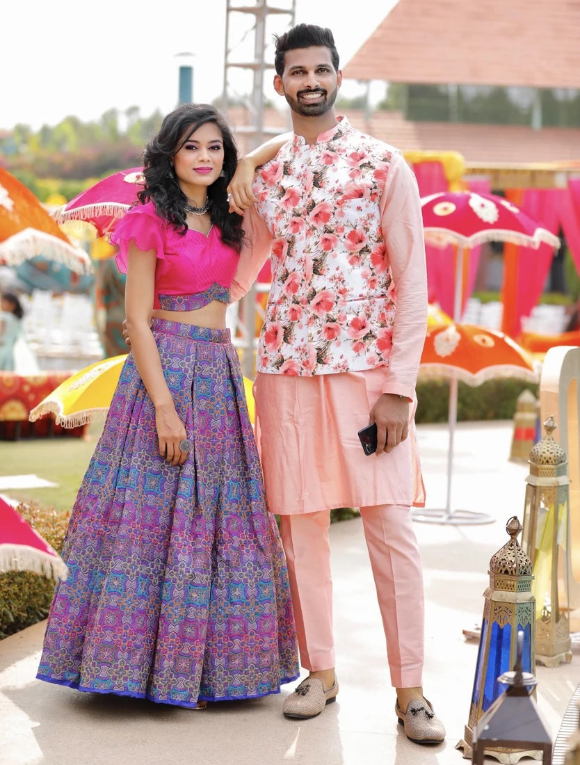 A reference photo of two people in coordinated pink and purple outfits