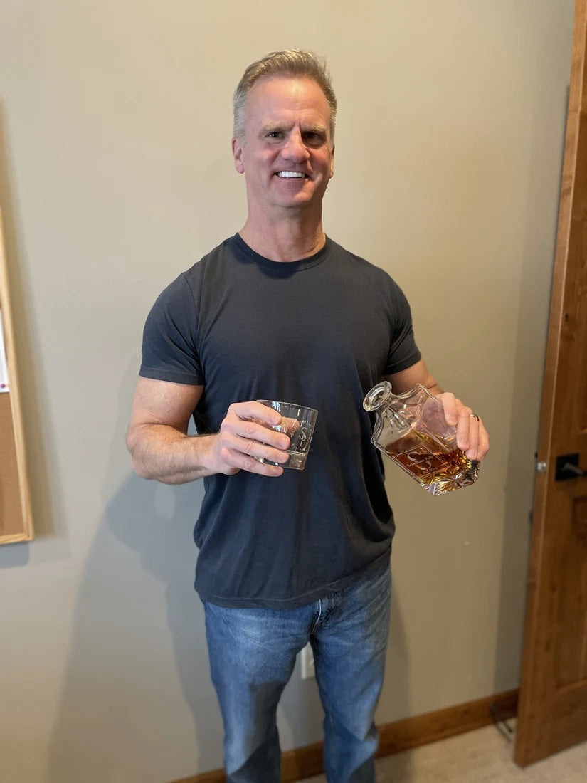 A reference photo of a man holding a glass and a bottle